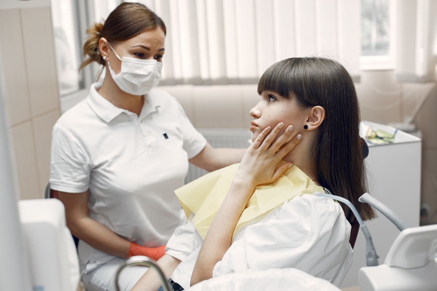 Dentist examining a patient with tooth pain