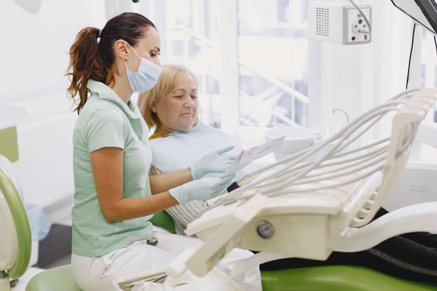 Dentist talking a patient through a check-up